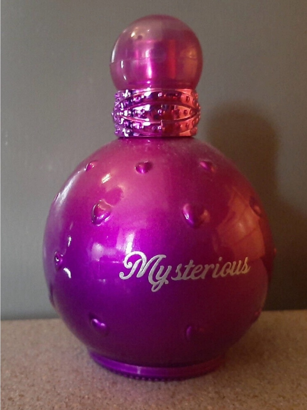 Mysterious Round Purple Pink Fragrance Bottle over half full